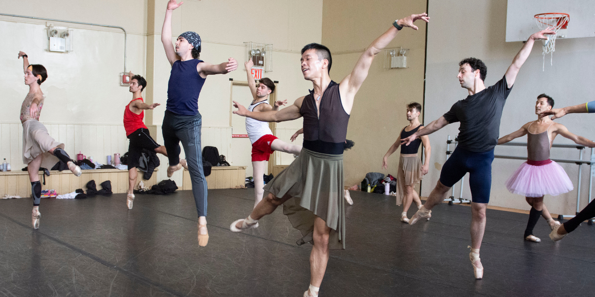 A group of dancers from the Trocks dance in rehearsal.