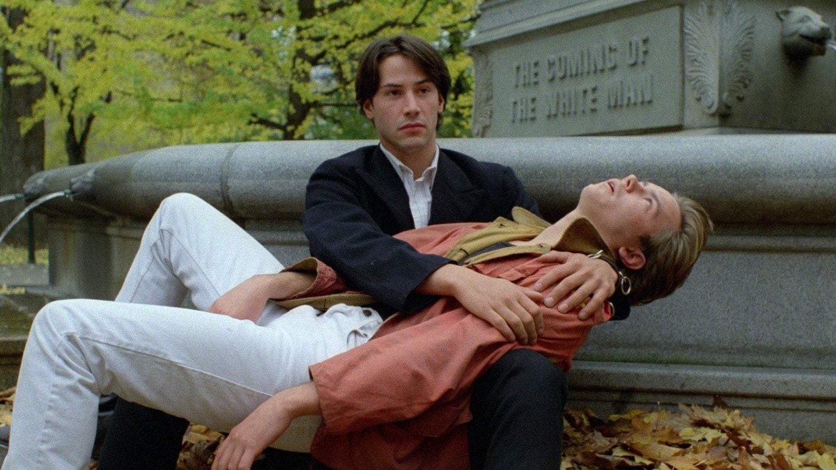 The best gay guy movies of all time: River Phoenix sleeps in Keanu Reeves' arms by a statue.