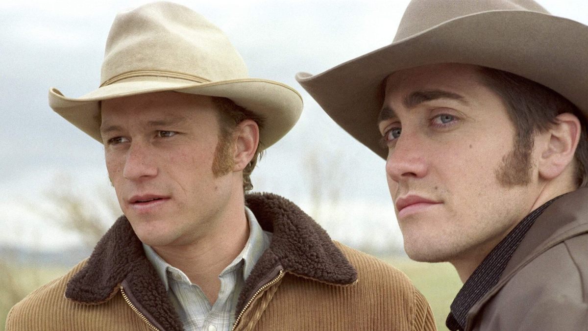 Heath Ledger and Jack Gyllenhaal look off in the distance wearing cowboy hats.