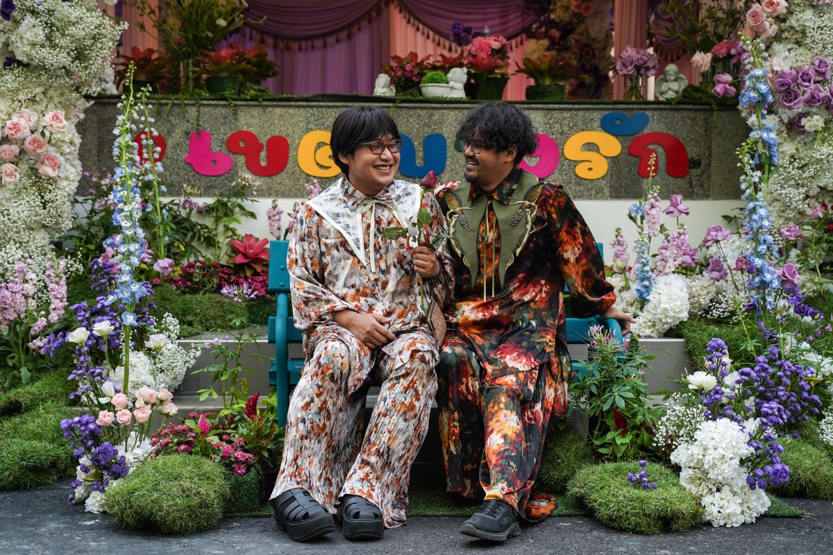 A couple poses for pictures at a marriage during an event to mark the country's same-sex marriage law coming into effect in BangRak District, Bangkok, Thailand, on January 23, 2025. (Photo by Anusak Laowilas/NurPhoto via Getty Images)