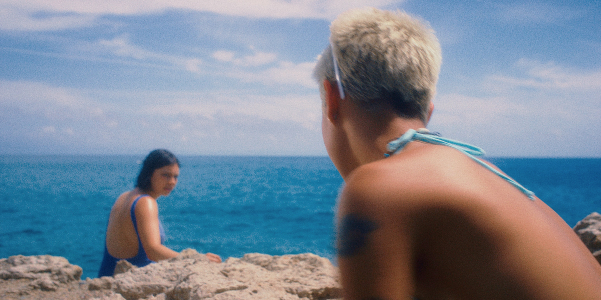 Kelley O'Hara and Tusk interview about the short film Ripe! Raina Landolfi and Rita Roca gaze at each other on a rocky beach