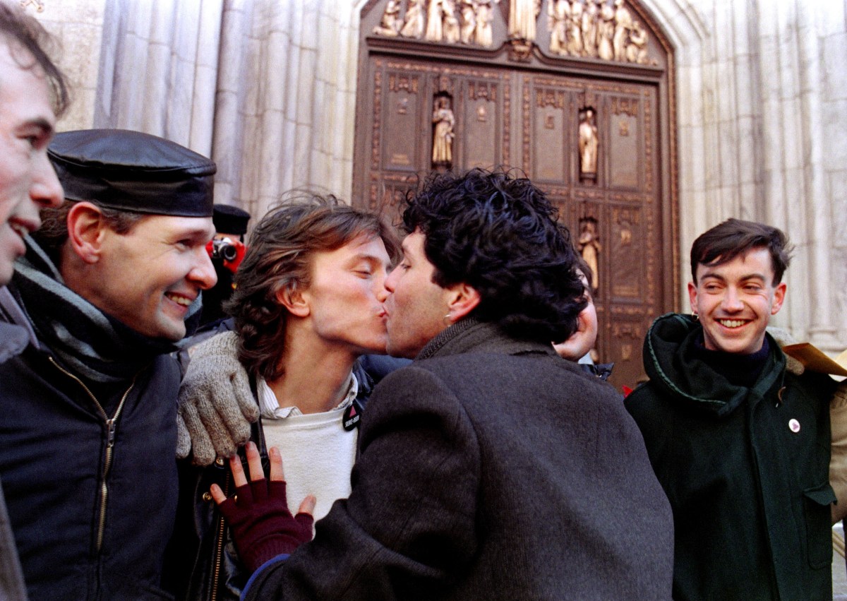 Members of the Lesbian and Gay community stage a Valentine 's Day "Kiss-In" 14 February 1988 outside St Patrick's Cathedral in New York to present a message of their unity and love in the face of the "church condoning anti-gay and anti-lesbian violence". (Photo by MARIA BASTONE / AFP) (Photo by MARIA BASTONE/AFP via Getty Images)