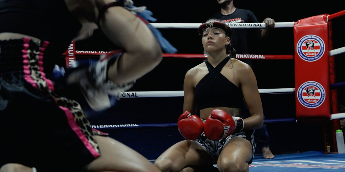 Quintessa Swindell interview: Swindell on their knees in a boxing ring with their eyes closed