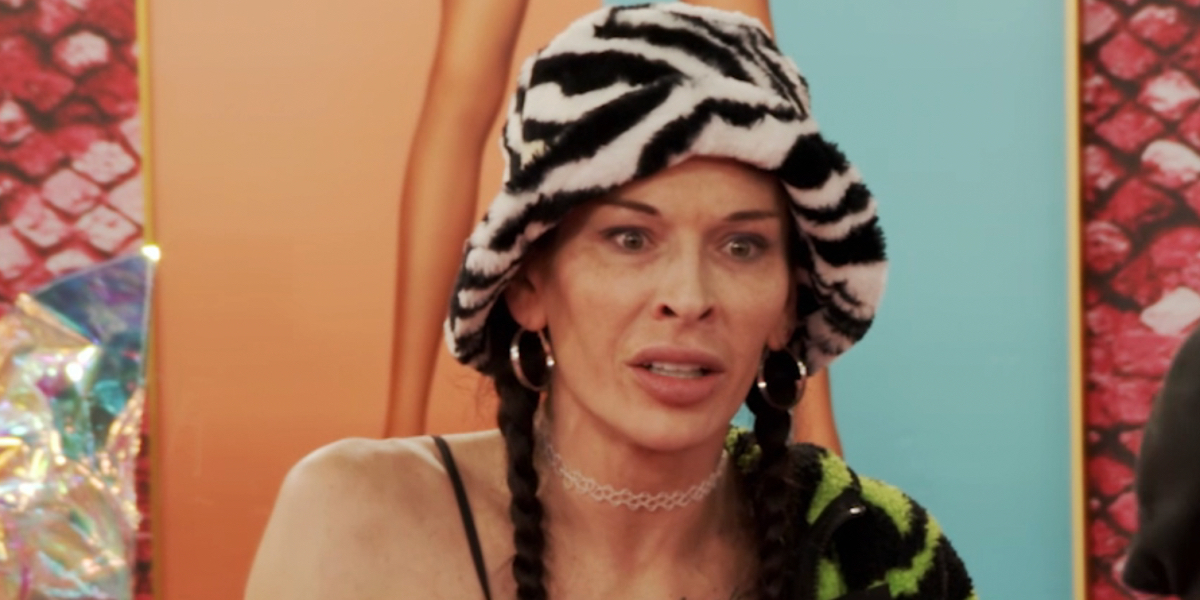 RuPaul's Drag Race episode 1706 recap: a close up on Lexi looking pissed out of drag with a zebra print hat