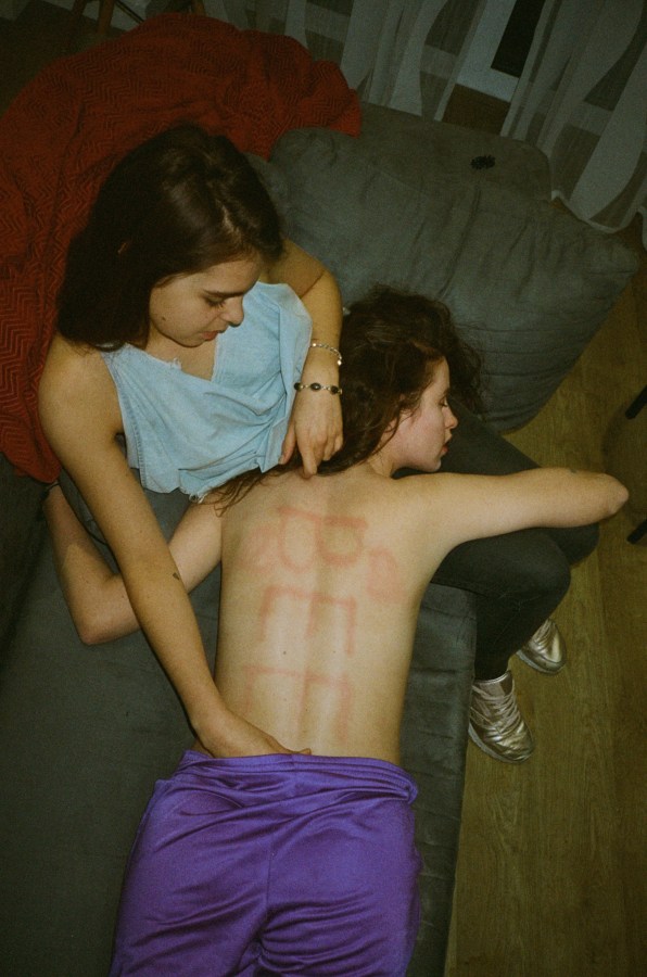 girl drawing on someone's back