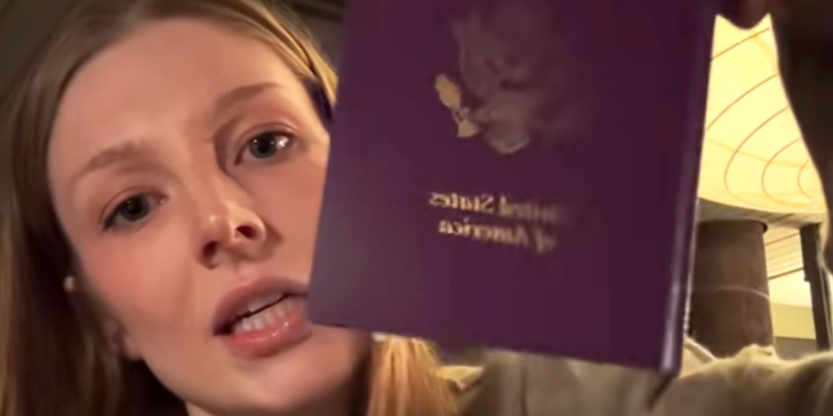 Hunter Schafer holds up her new passport