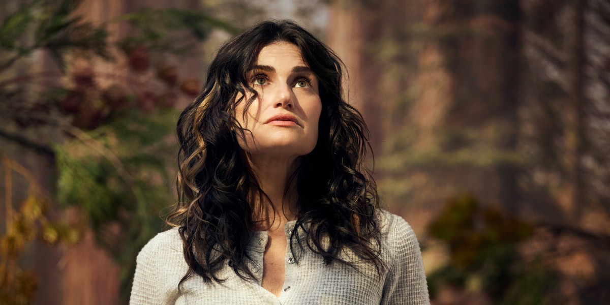 Redwood on Broadway, Idina Menzel as lesbian Jesse looks up to the sky with trees behind her