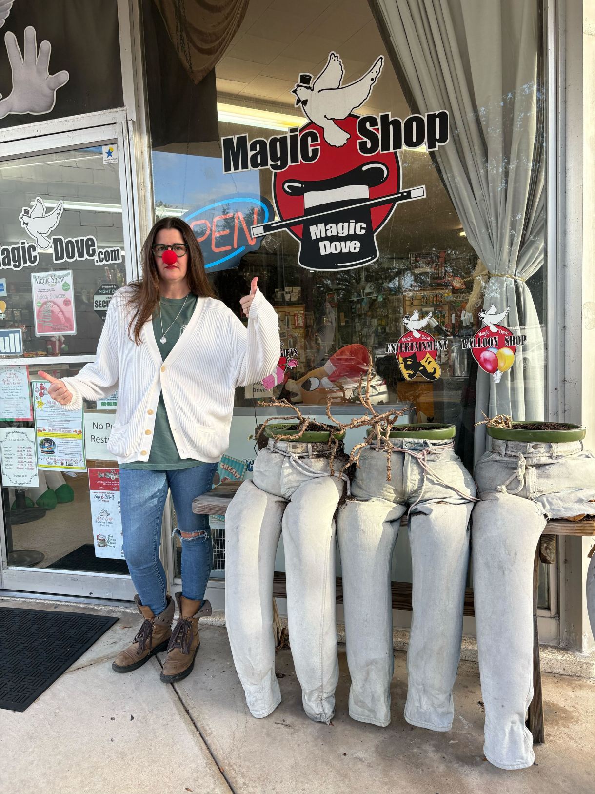 Kristen in a clown nose in front of a magic shop